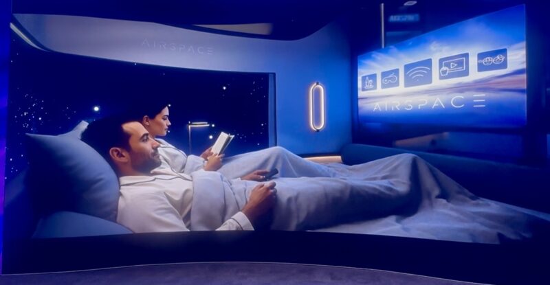 Two passengers tuck into the double bed, preparing to sleep in the center suite