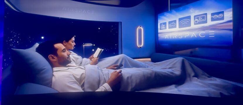 Two passengers tuck into the double bed, preparing to sleep in the center suite
