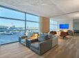 Floor to ceiling windows look out onto the ramp in this EL AL lounge