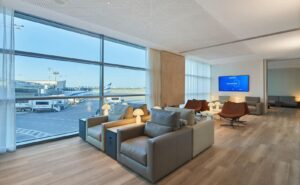 Floor to ceiling windows look out onto the ramp in this EL AL lounge