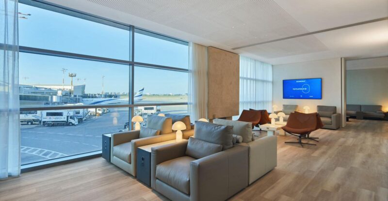 Floor to ceiling windows look out onto the ramp in this EL AL lounge