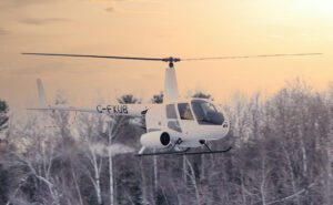 Robinson R44 in flight on a snow dusted day.