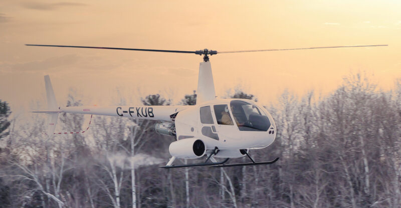 Robinson R44 in flight on a snow dusted day.
