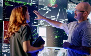 Controllers interact with advanced airspace surveillance and automation displays at a Collins Aerospace facility, supported by radar systems like those that will be produced at the company’s expanded Largo, Florida site, helping enhance situational awareness and decision-making in complex airspace environments.