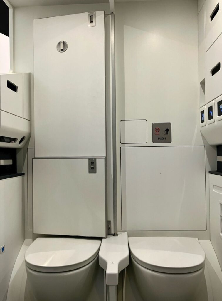 Diehl Aviation Space³ shows two lavatories side-by-side opened up to create one large space.