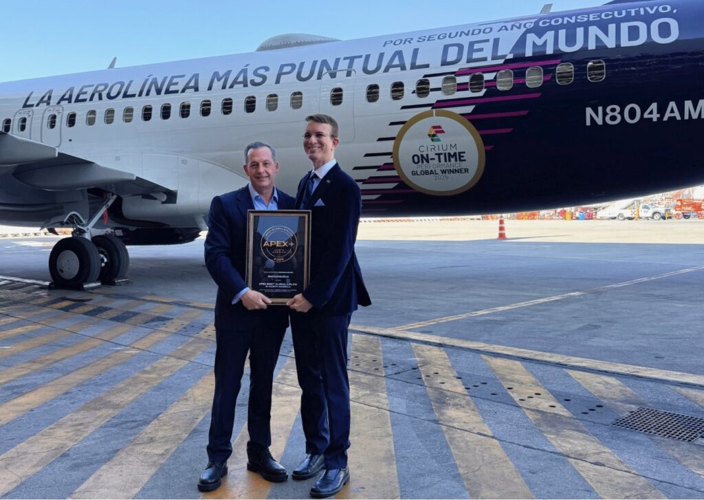 Aeromexico and APEX CEOs pose for a picture in front of an Aeromexico jet. Both men are holding the 2026 APEX award 