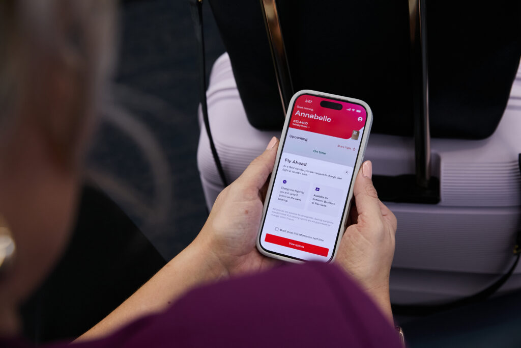 A Virgin Australia passenger's flight information is displayed on their mobile device.