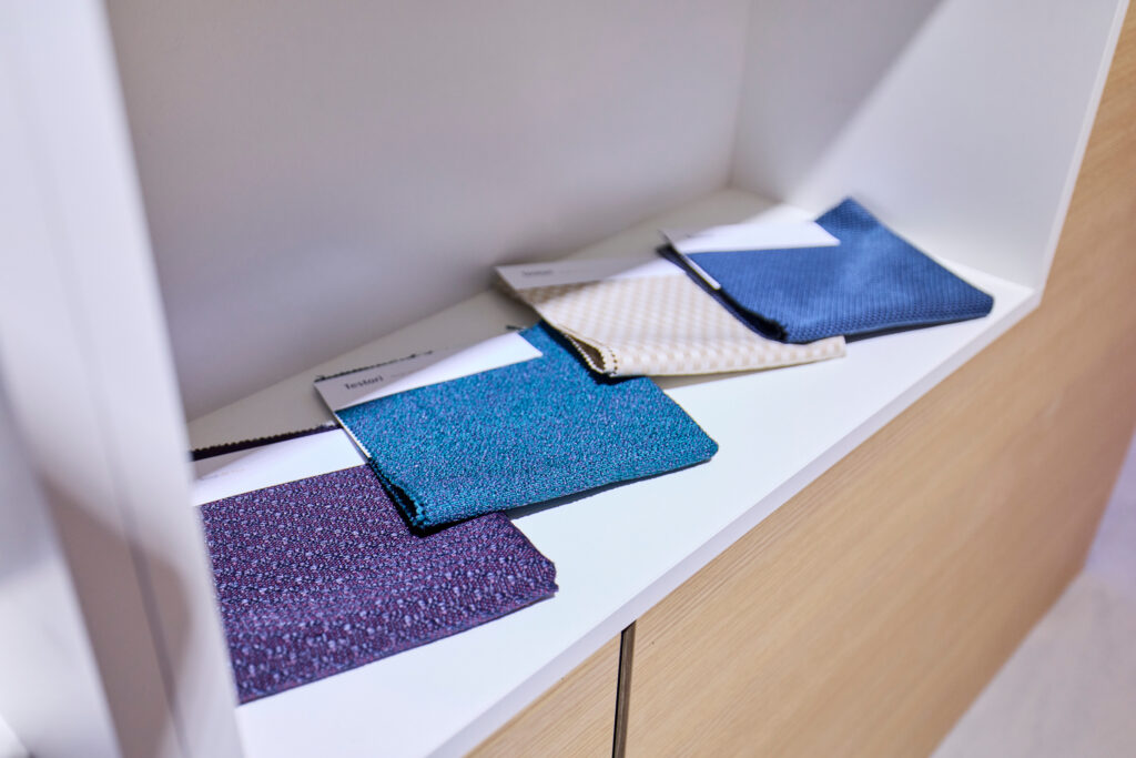 Testori's sustainable curtains in different colors on display on Boeing's stand at AIX 2026