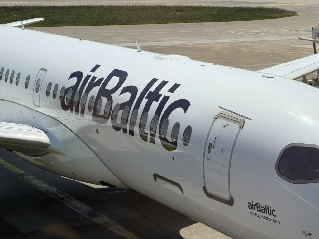 airBaltic A220 aircraft next to the Air Serbia aircraft. The A220 is fitted with Starlink