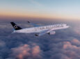 An aircraft with Star Alliance livery in flight.