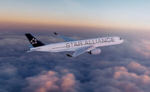 An aircraft with Star Alliance livery in flight.