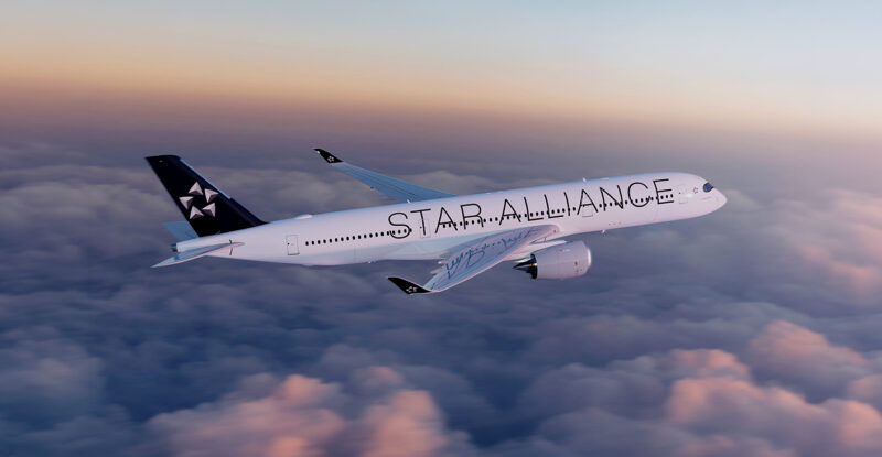 An aircraft with Star Alliance livery in flight.