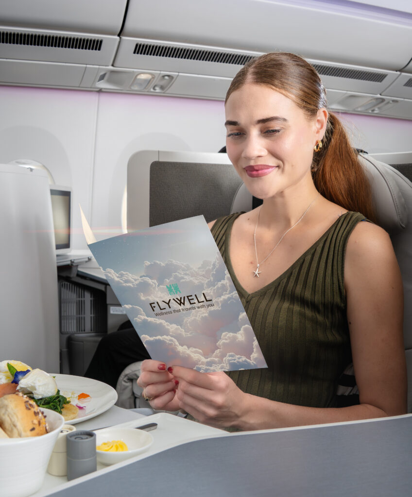 A passenger is reading the wellness menu by Fiji Airways.