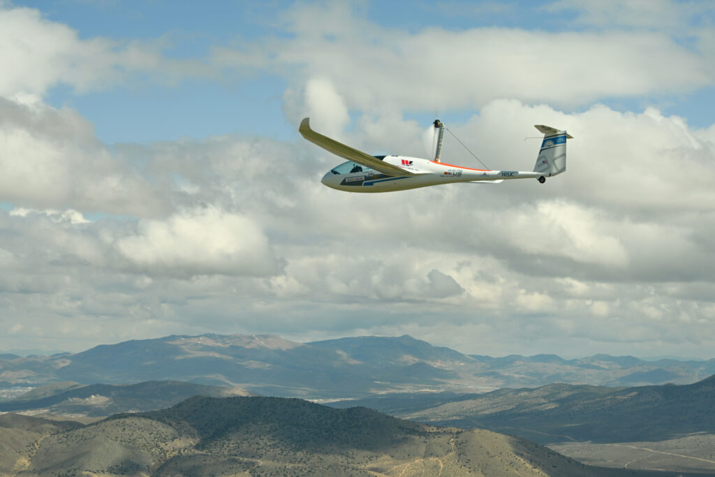 The electric plane in flight over a mountain range
