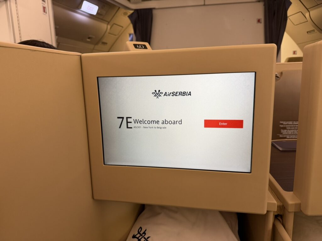 A welcome message is displayed on the IFE screen.