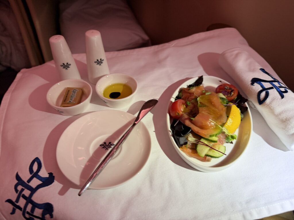 A salad is served to the passenger as part of their meal in flight.