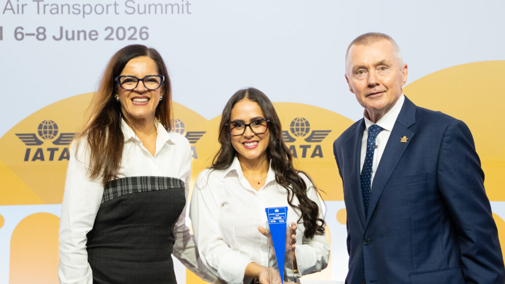 Juliana Rios, Daiane Mendes and Willie Walsh standing together for a photo at the 82nd AGM.