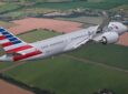 American Airlines aircraft in flight over a farm field.