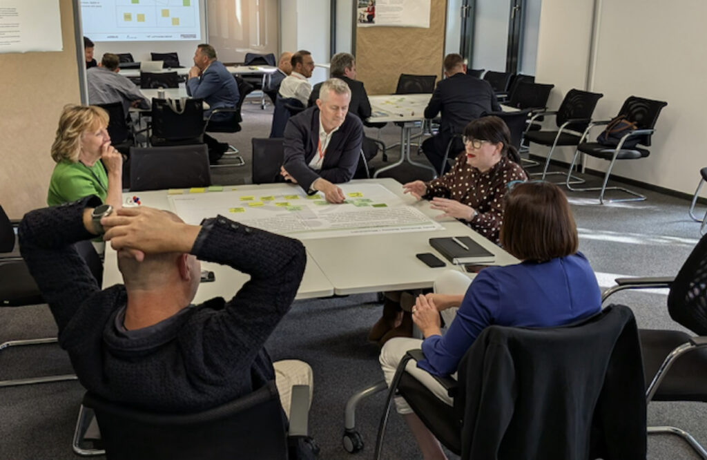 Different tables are set up with various working groups at the RedCabin Summit.