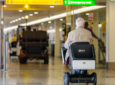 An elderly man uses the WHILL Autonomous Service at Heathrow Airport Terminal 3.