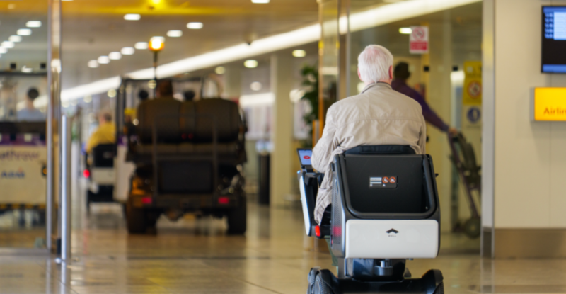 An elderly man uses the WHILL Autonomous Service at Heathrow Airport Terminal 3.