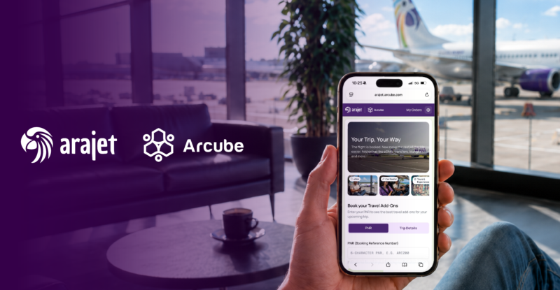 Arajet and Arcube logos over an airport lounge. A passenger is holding up a mobile device.
