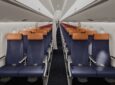 LATAM Embraer E195-E2 new premium economy includes blue seats and orange headrests.