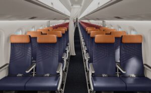 LATAM Embraer E195-E2 new premium economy includes blue seats and orange headrests.