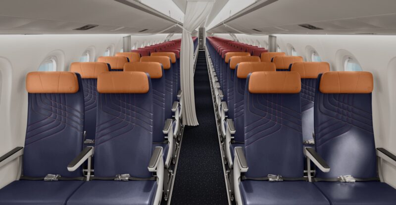 LATAM Embraer E195-E2 new premium economy includes blue seats and orange headrests.