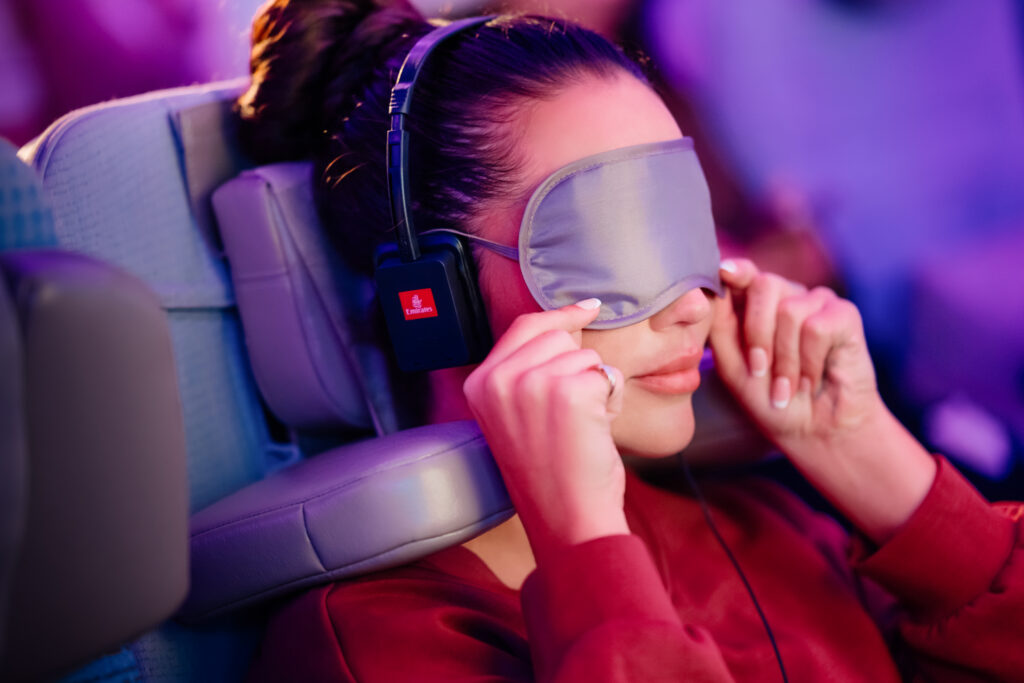A woman relaxes while using the Emirates U-Dream Headrest