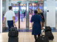 Airline crew members walking towards the exit of Ontario International Airport.