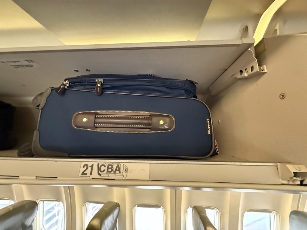 Luggage is seen here stowed away in the overhead bins.