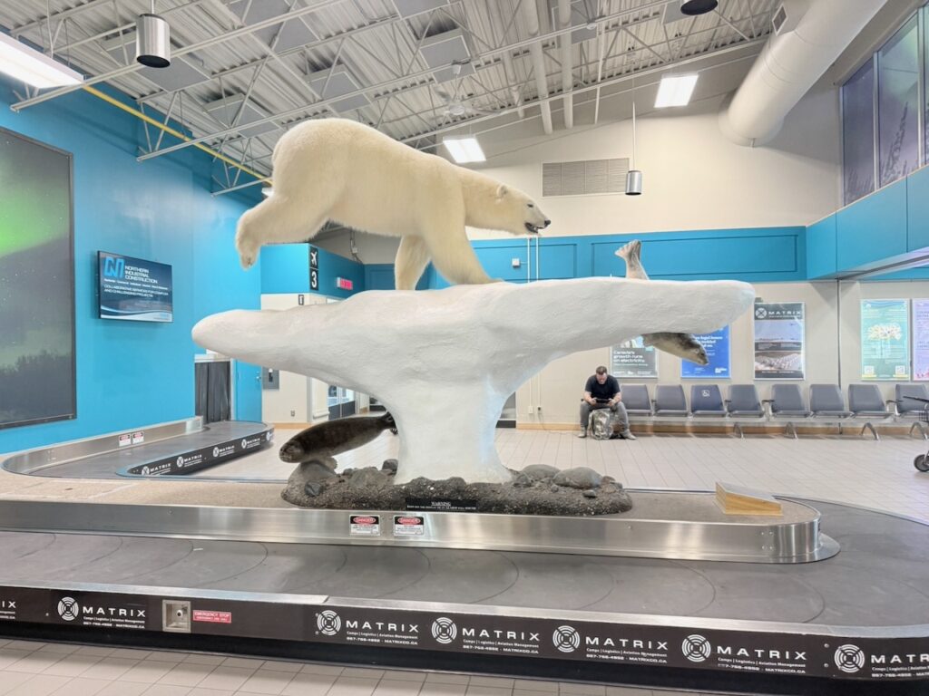 A Polar Bear statue welcomes passengers to baggage claim at Yellowknife.