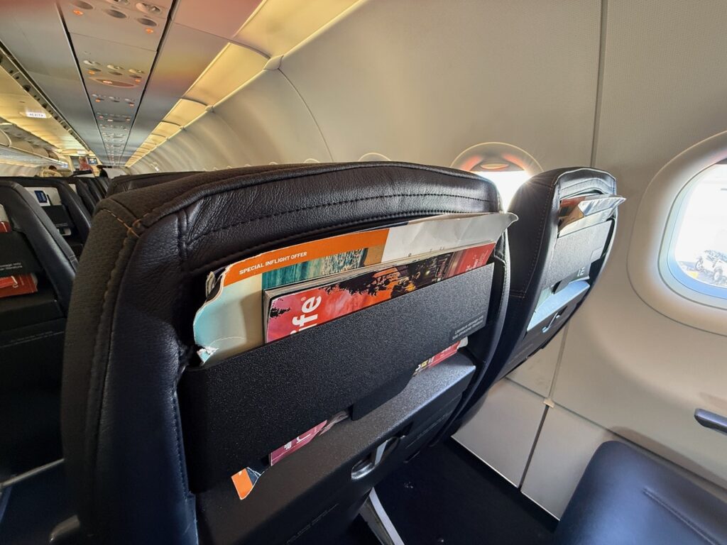 A close up of Allegiant's Acro Series 3 economy class seat literature pocket.