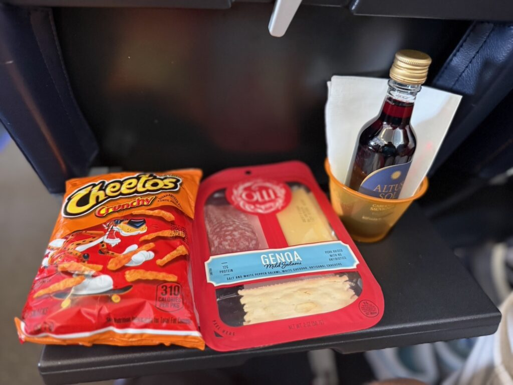 Snacks sit on the aircraft tray table.