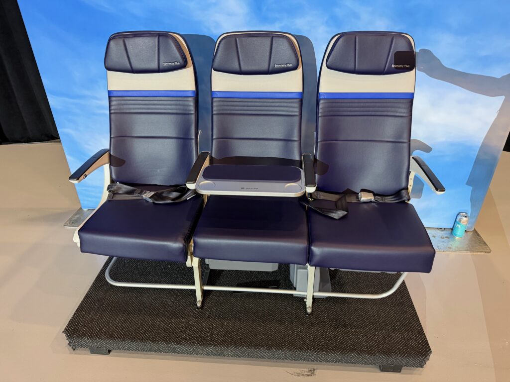 Seat triple on the hangar floor with the middle seat blocked; this is United's new EuroBiz-styled extra-legroom, extra elbow room offering