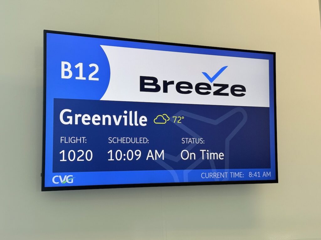 Screen says B12, the boarding gate for Breeze Airways' Greenville flight on this day.
