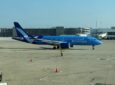 A Breeze Airways A220-300 parked on a sunny day