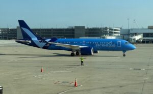 A Breeze Airways A220-300 parked on a sunny day