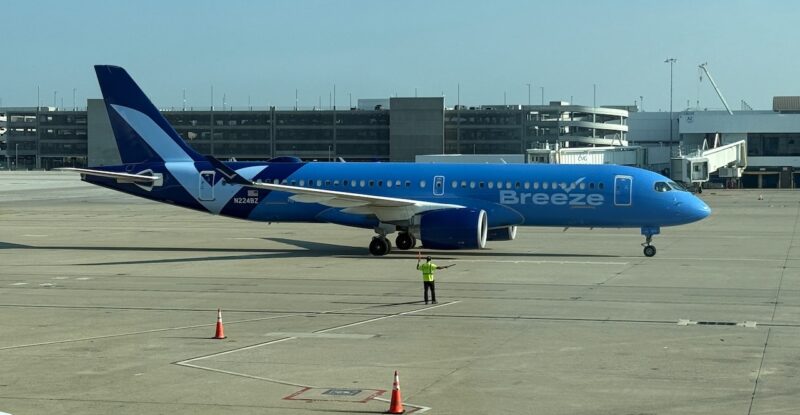 A Breeze Airways A220-300 parked on a sunny day