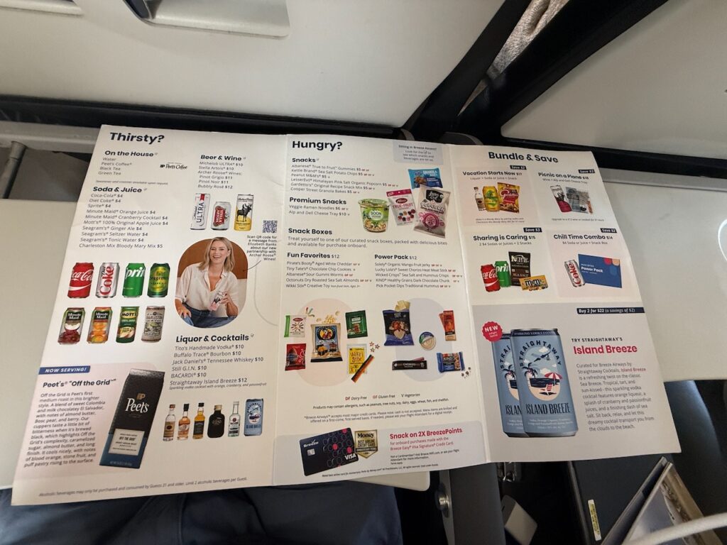 Breeze's inflight menu displayed on the tray table.