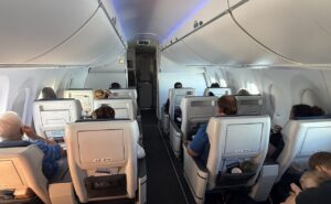 Passengers seated in Ascent recliners up front on the A220