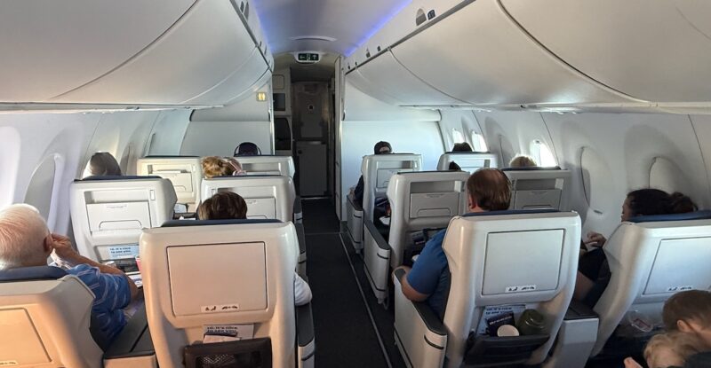Passengers seated in Ascent recliners up front on the A220