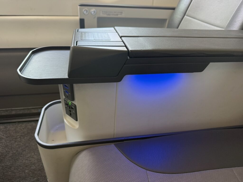 Blue lighting coming from the aircraft seats arm rest.