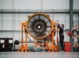 Work is being done on an engine in the hangar.
