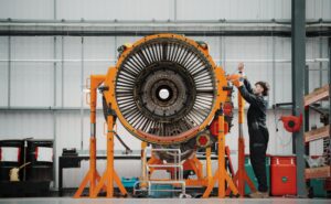 Work is being done on an engine in the hangar.