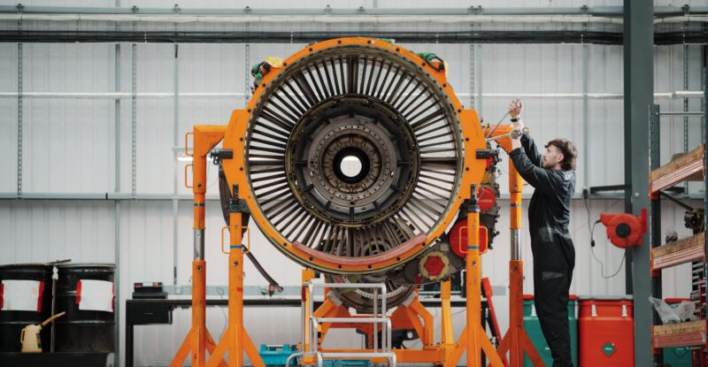 Work is being done on an engine in the hangar.