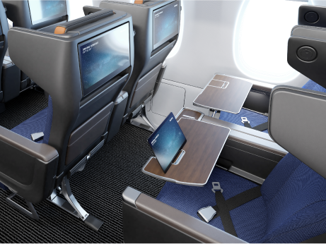 RECARO R4 Premium class seat in blue with grey headrests. A mobile device is placed the the dedicated slot on the tray table. A large seatback IFE screen is also in view.