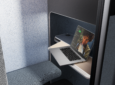 A laptop sits on a table inside the Boeing EnCore E-Lounge booth