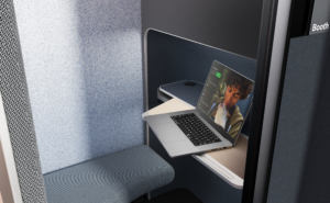A laptop sits on a table inside the Boeing EnCore E-Lounge booth